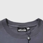 A close-up view of the inner neck collar tag and brand branding on a grey Hellstar Sports Core Logo Gel T-Shirt.