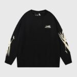 Front view of a premium black Hellstar Sports crewneck sweater featuring signature star sleeve graphics and logo.