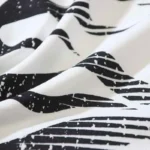 Close-up view of the premium cotton fabric texture featuring the graphic screen print of the Hellstar Sports Family T-shirt.