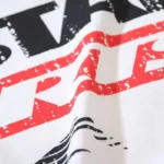 Close-up view of the Hellstar Sports Family T-shirt featuring bold red and black distressed screen-printed graphic text.
