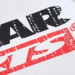 Close-up of the distressed black and red graphic print on a premium white Hellstar Sports Family cotton T-shirt.