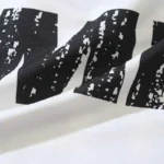 Close-up view of the premium cotton fabric texture and graphic screen print on a white Hellstar Sports Family T-shirt.