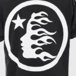 Hellstar Sports black tee close-up featuring a white flame-profile graphic inside a circle with a star, vintage sports style