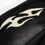 Close up of the Hellstar Sports Flame shorts in black featuring the signature cream flame graphic detail.