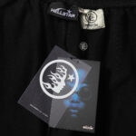 A close-up view of the Hellstar Sports Flame Shorts in black, showcasing the branding and detailed authentic tags.