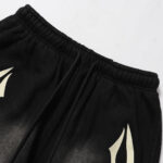 Close-up view of the elastic waistband and drawstring detail on the black Hellstar Sports Flame streetwear shorts.