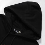 Close-up view of the black hood and branded interior tag on the Hellstar Sports Future Flame Hoodie garment.