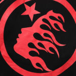 Hellstar Sports Future Flame tracksuit black fabric featuring a red circular face logo and star graphic detail.