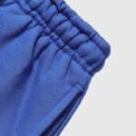 Close-up view of the elastic waistband and premium blue fabric texture on the Hellstar Sports Gel sweatpants.