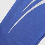 Close-up of the vibrant blue Hellstar Sports Gel tracksuit fabric featuring distinct white graphic logo detailing.