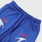 Closeup view of the fabric and elastic drawstring waistband on Hellstar Sports Gel blue streetwear sweatpants.