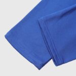 Close-up view of the premium blue cotton fabric and detailed stitching on Hellstar Sports blue sweatpants.