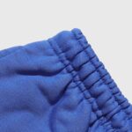 Close-up view of the blue elastic waistband on Hellstar Sports Gel sweatpants showing the durable gathered stitching.