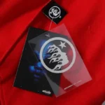 Hellstar Sports Gel Sweatpant in red featuring the signature branded clothing tag and graphic hang tag detail.