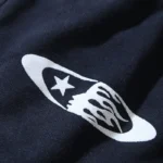 Close-up of the graphic print on the premium fabric of a black Hellstar Sports tracksuit for a luxury streetwear look.