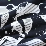 Close-up of the black fabric on the Hellstar Sports graphic print tracksuit featuring detailed white screen printing.