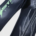 Black Hellstar Sports graphic print sweatpants featuring bold green lettering and a faded washed vintage effect.