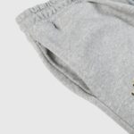 Close-up view showing the side pocket detail and elastic waistband of the premium grey Hellstar Sports cotton sweatpants.