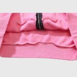 Close-up view of the ribbed hem and black zipper detail on the premium pink Hellstar Sports cotton zip-up hoodie.