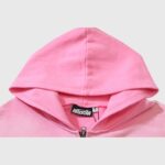 Close-up view of the premium pink Hellstar Sports zip-up hoodie featuring the signature Hellstar branding label.