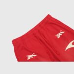 Hellstar Sports red sweatpants featuring a vintage washed finish, custom cosmic emblem graphics, and a drawstring waistband.