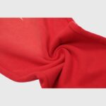 Close-up view of the premium heavyweight red fleece fabric used for Hellstar Sports streetwear sweatpants design.