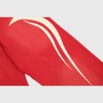 Detail shot of the Hellstar Sports red sweatpants featuring custom white screen-printed graphic logo artwork.
