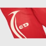 Closeup of the Hellstar Sports red sweatpants showing the signature white graphic print on the premium fleece leg.