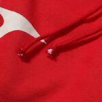 Close-up of the red Hellstar Sports tracksuit featuring premium cotton fabric and adjustable drawstring closure details.