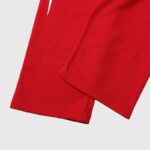 Close-up view of the premium red fabric and stitching details on the Hellstar Sports tracksuit for men and women.