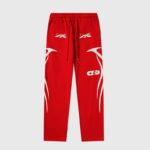 Bright red Hellstar Sports tracksuit pants featuring white graphic star logos and flame detailing on the sides.