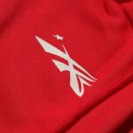 White logo detail printed on premium red cotton fabric from the Hellstar Sports tracksuit collection.