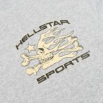 Hellstar Sports grey t-shirt featuring a detailed cream-colored graphic of a flaming skull and crossbones with a star.