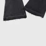 Hellstar Sports Star black denim jeans featuring a distinct frayed distressed hem detail for a streetwear look