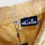 Close-up view of the interior yellow Hellstar Sports sweatpants label and garment construction details.