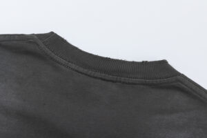 Close-up view of the black collar detail on a vintage washed Hellstar Sports T-shirt made of 100% cotton fabric.