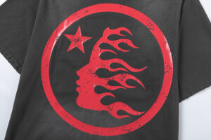 Hellstar Sports black t-shirt featuring a vintage washed graphic screen print of a red flaming face and a star logo.