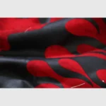 Close-up view of the premium red and black tie-dye fabric on a Hellstar Sports Skull Hoodie streetwear apparel piece.