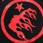 Hellstar Sports tracksuit black and red fabric showing the iconic graphic logo with a face and a star in red print.