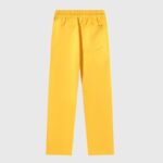 A detailed back view of the vibrant yellow Hellstar Sports sweatpants showing the elastic waistband and pocket detail.