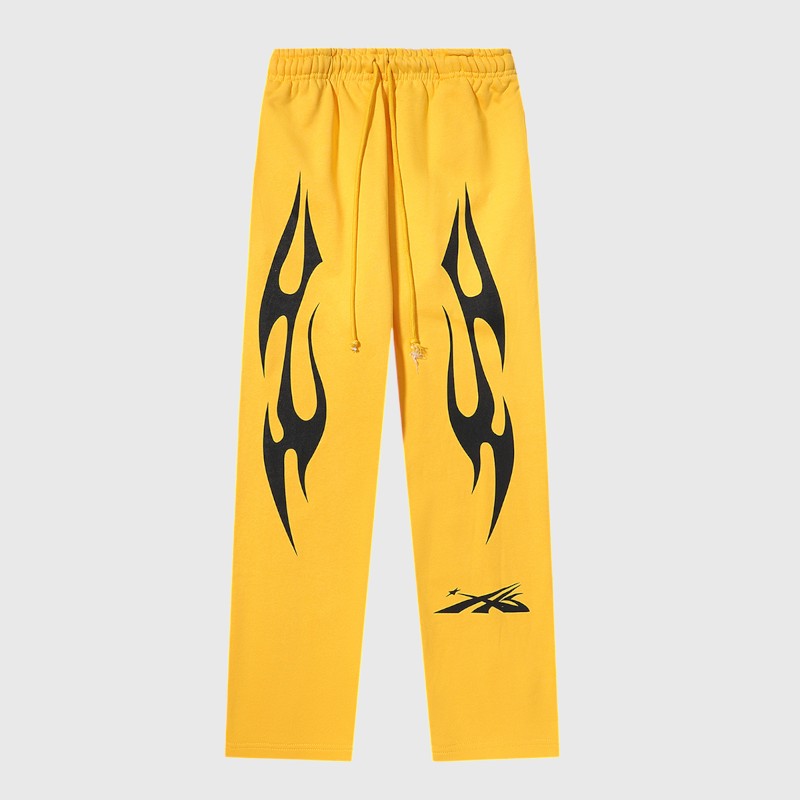 Hellstar Sports Yellow Sweatpants Front View Front view of Hellstar Sports yellow sweatpants featuring black graphic flame prints and drawstring closure