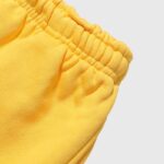 Close-up view of the elastic waistband detail on the premium heavyweight fleece Hellstar Sports yellow sweatpants.