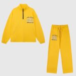 Hellstar Sports yellow tracksuit set featuring a half-zip pullover jacket and matching sweatpants with logo branding.