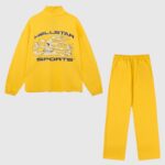 Hellstar Sports yellow tracksuit featuring a graphic logo jacket and matching cotton sweatpants for streetwear.