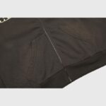 Close-up view of the premium black cotton fabric and metal zipper detail on a Hellstar Sports zip-up hoodie.