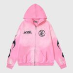 Front view of the Hellstar Studios pink zip-up hoodie featuring black graphic logos and flame details on the sleeves.