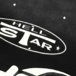 Close-up of the Hellstar Starry Sky t-shirt featuring the white logo print on black cotton fabric design.