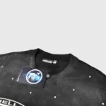 Detailed view of the collar and brand tag on the black Hellstar Starry Sky vintage washed graphic t-shirt.