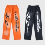 Pair of Hellstar Fire elastic sweatpants in orange and black featuring graphic flame and logo screen prints.