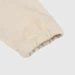 Close-up view of the beige sleeve cuff on a premium Hellstar Studios Zipper Sweater featuring soft cotton fabric.